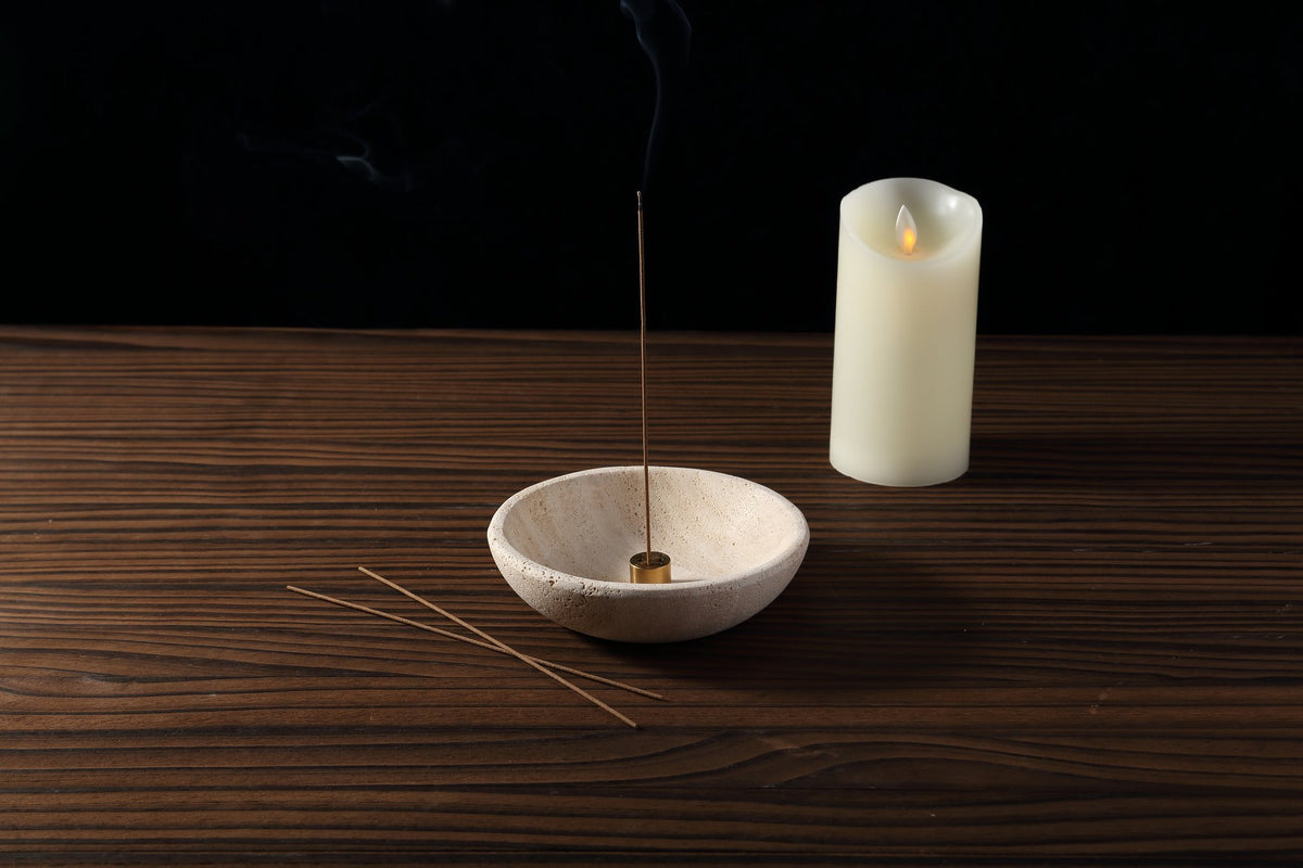 Koville Travertine incense holder displayed with pillar candle on wood surface
