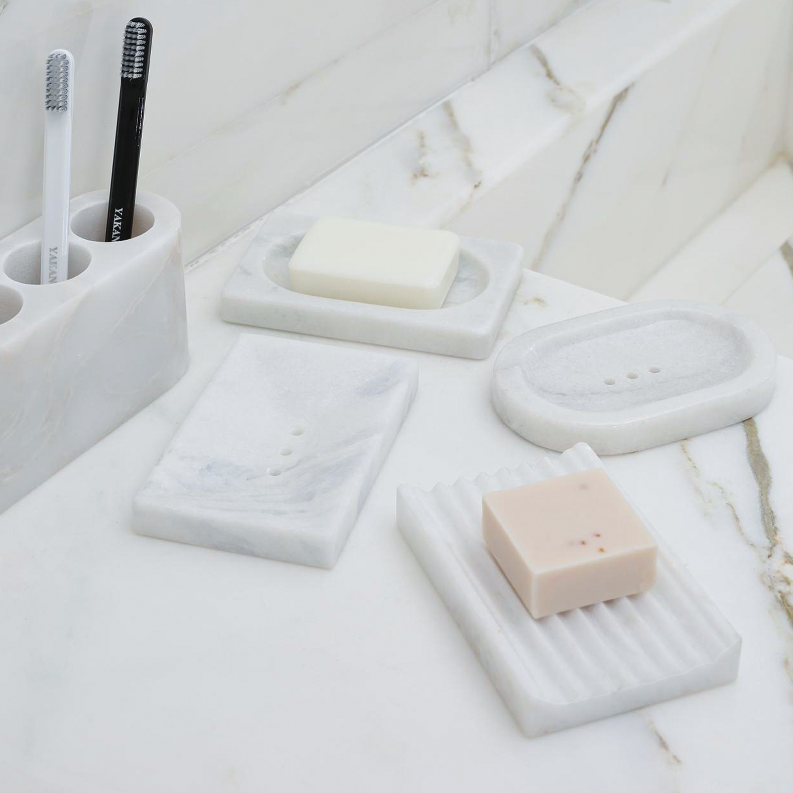 Koville Namib Fantasy marble square soap dish with oval inset with an oval recessed soap bed set into a square marble base for a bathroom vanity or shower ledge