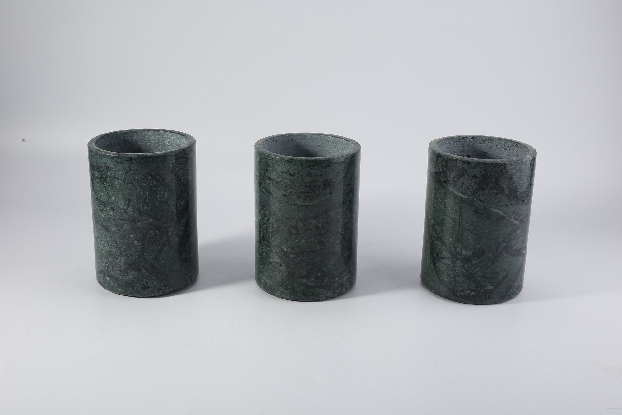 Koville Natural Stone Straight Wine Cooler in Indian Green on a dining table with a wine bottle