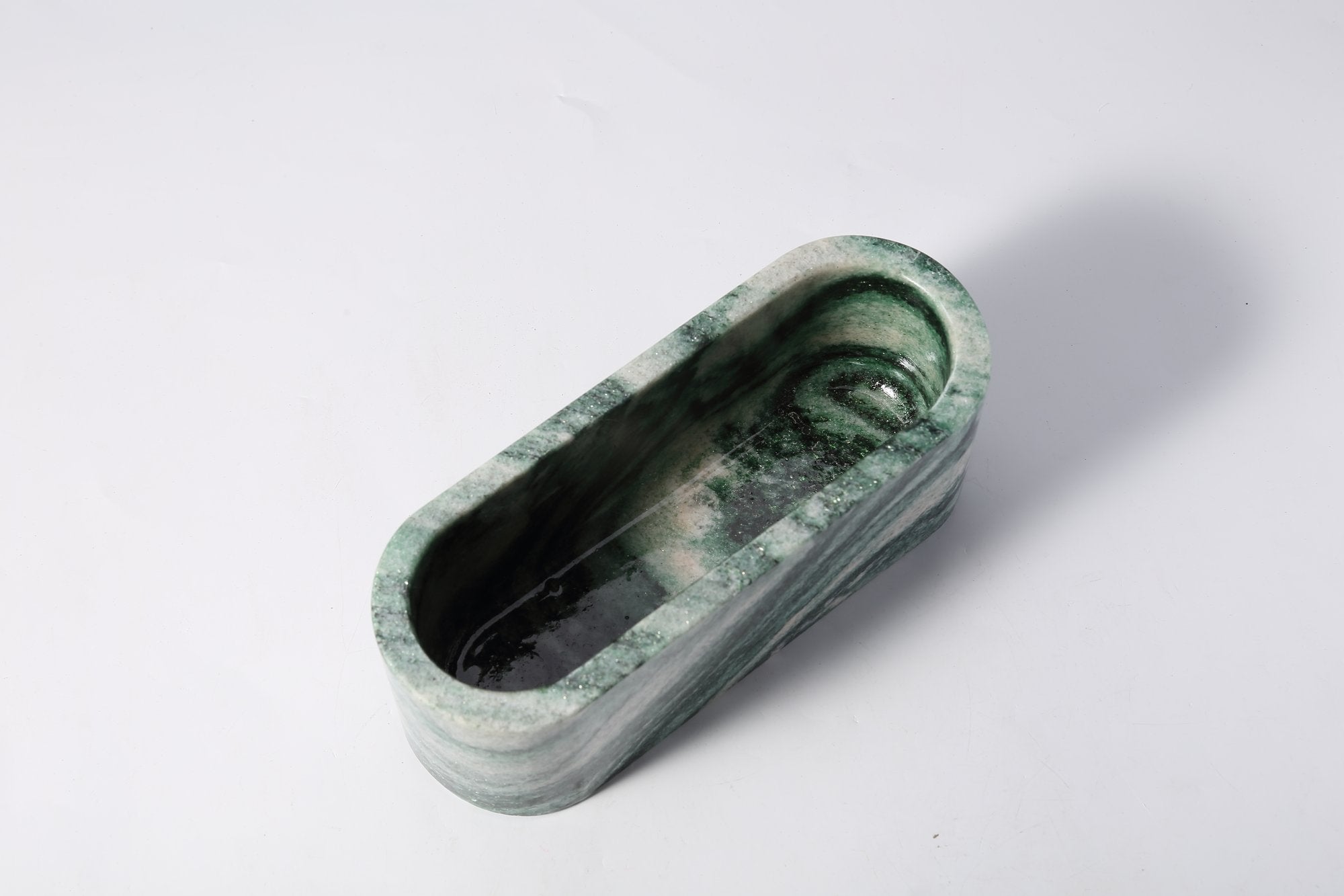 Koville natural marble candlelight cup 200 76 76 in Verde Lapponia with a lit tea light candle