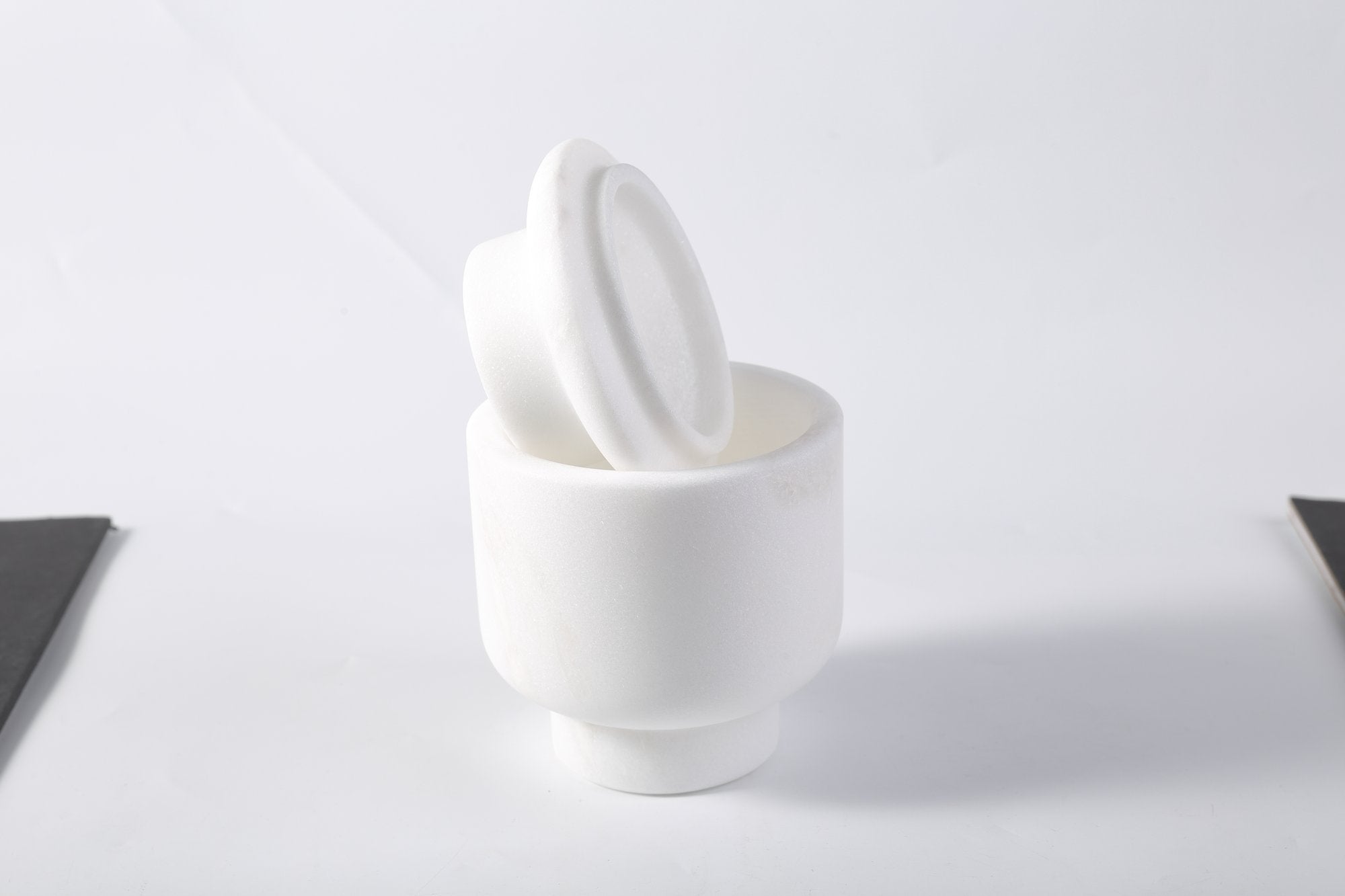 Koville natural marble candlelight cup d 100 t 140 in Namib Bianco with a lit tea light candle