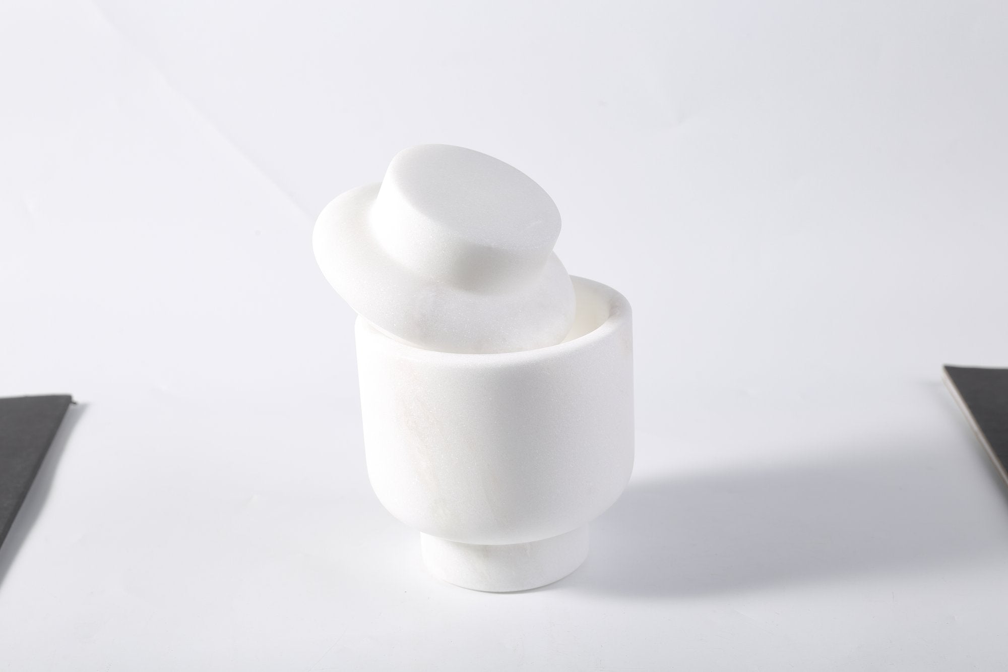 Koville natural marble candlelight cup d 100 t 140 in Namib Bianco with a lit tea light candle