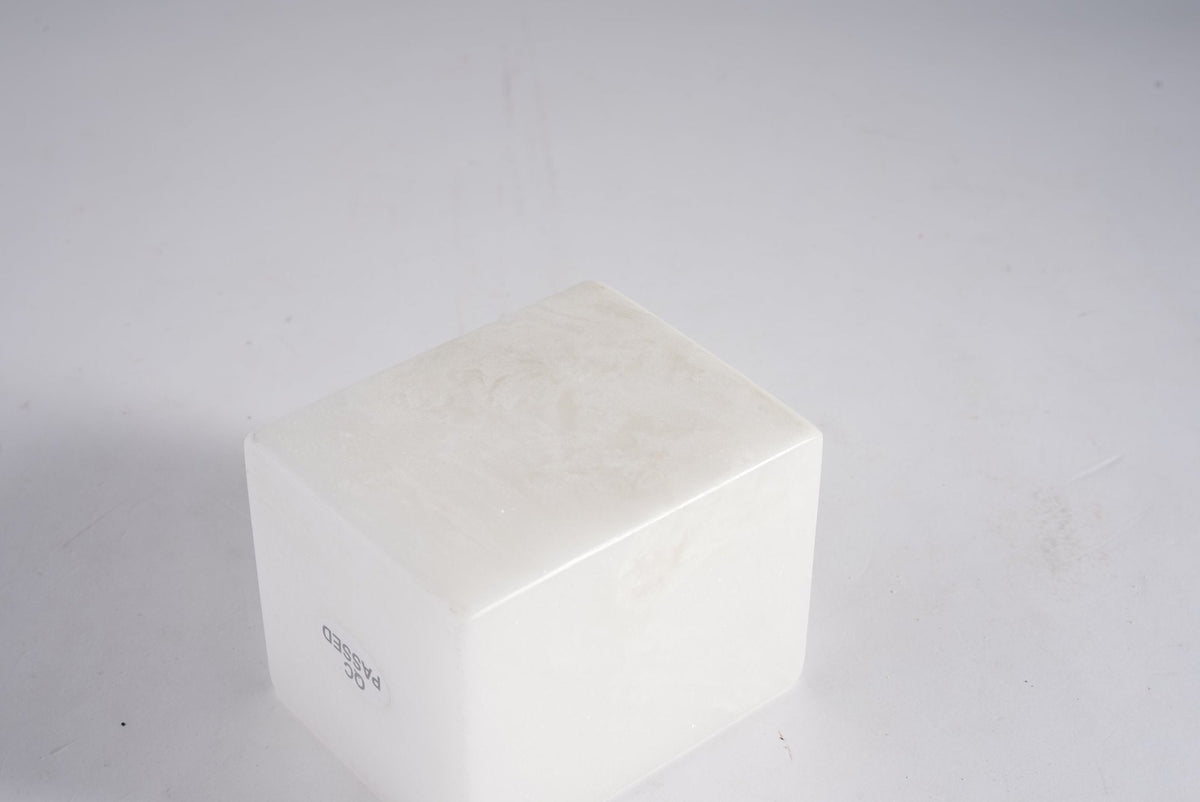 Koville candle holder in Namib Bianco with a lit tea light candle