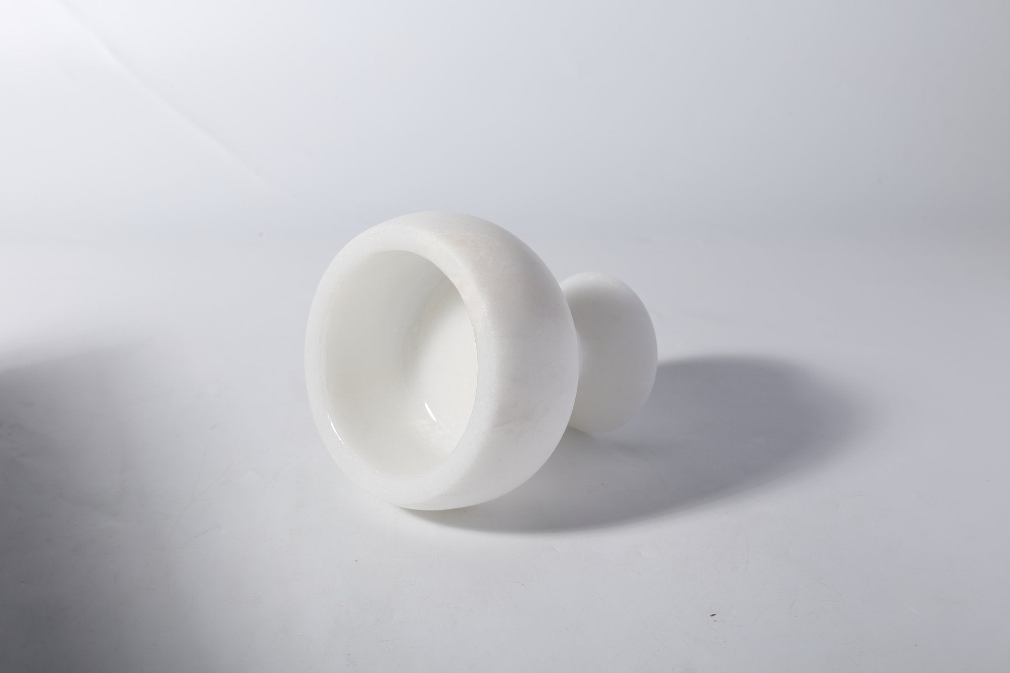 Koville natural marble candlelight cup d 99 in Namib Bianco with a lit tea light candle