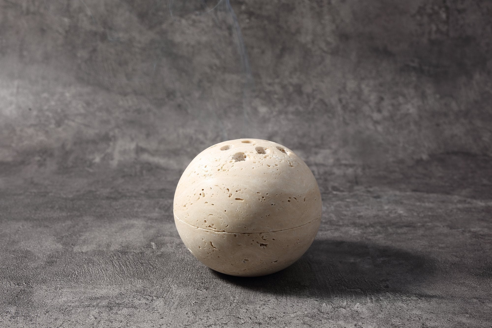 Koville natural marble incense burner d 100 in Travertino Romano with burning incense stick