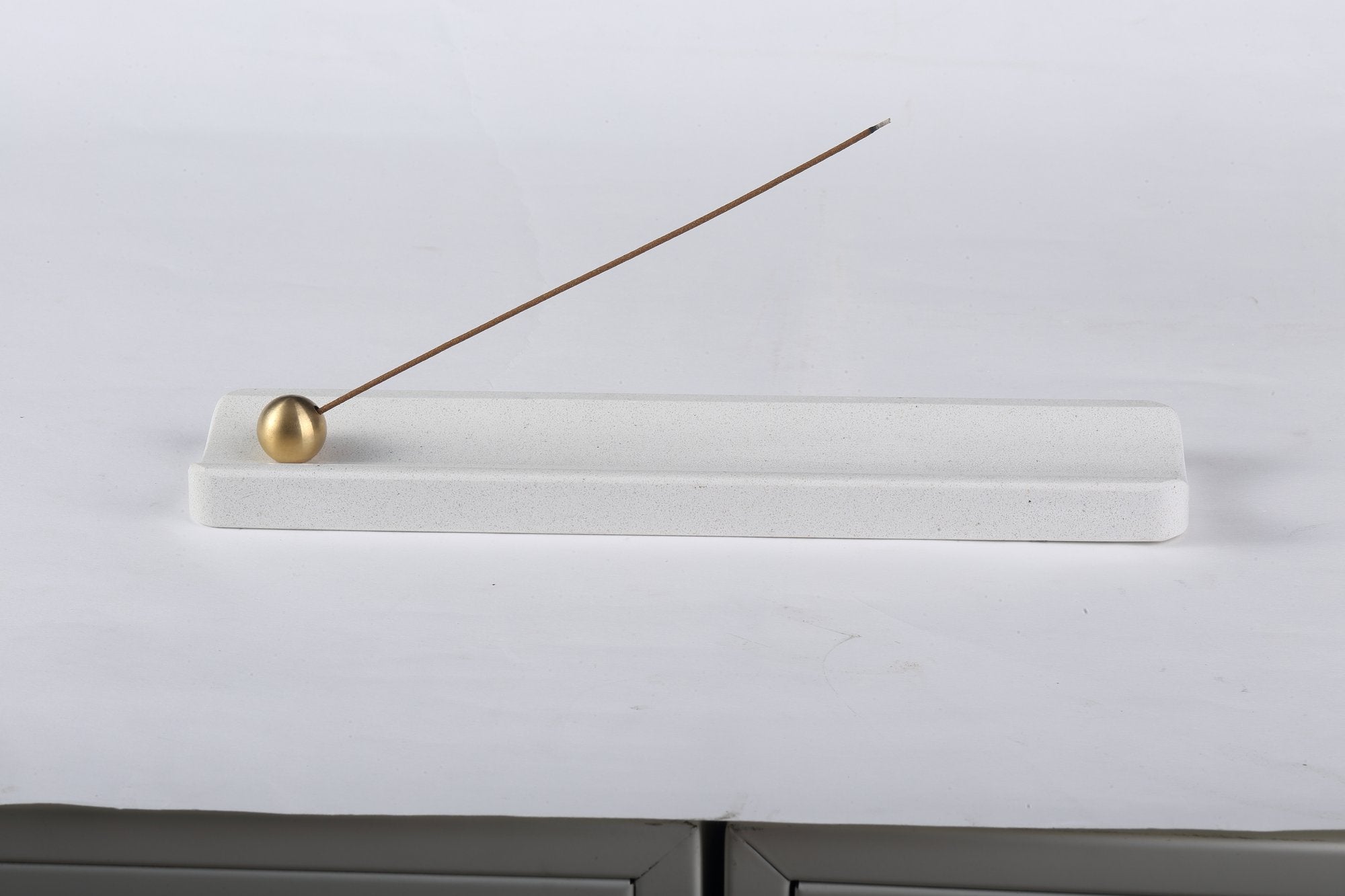 Koville natural marble incense holder in Ariete Quarella with burning incense stick