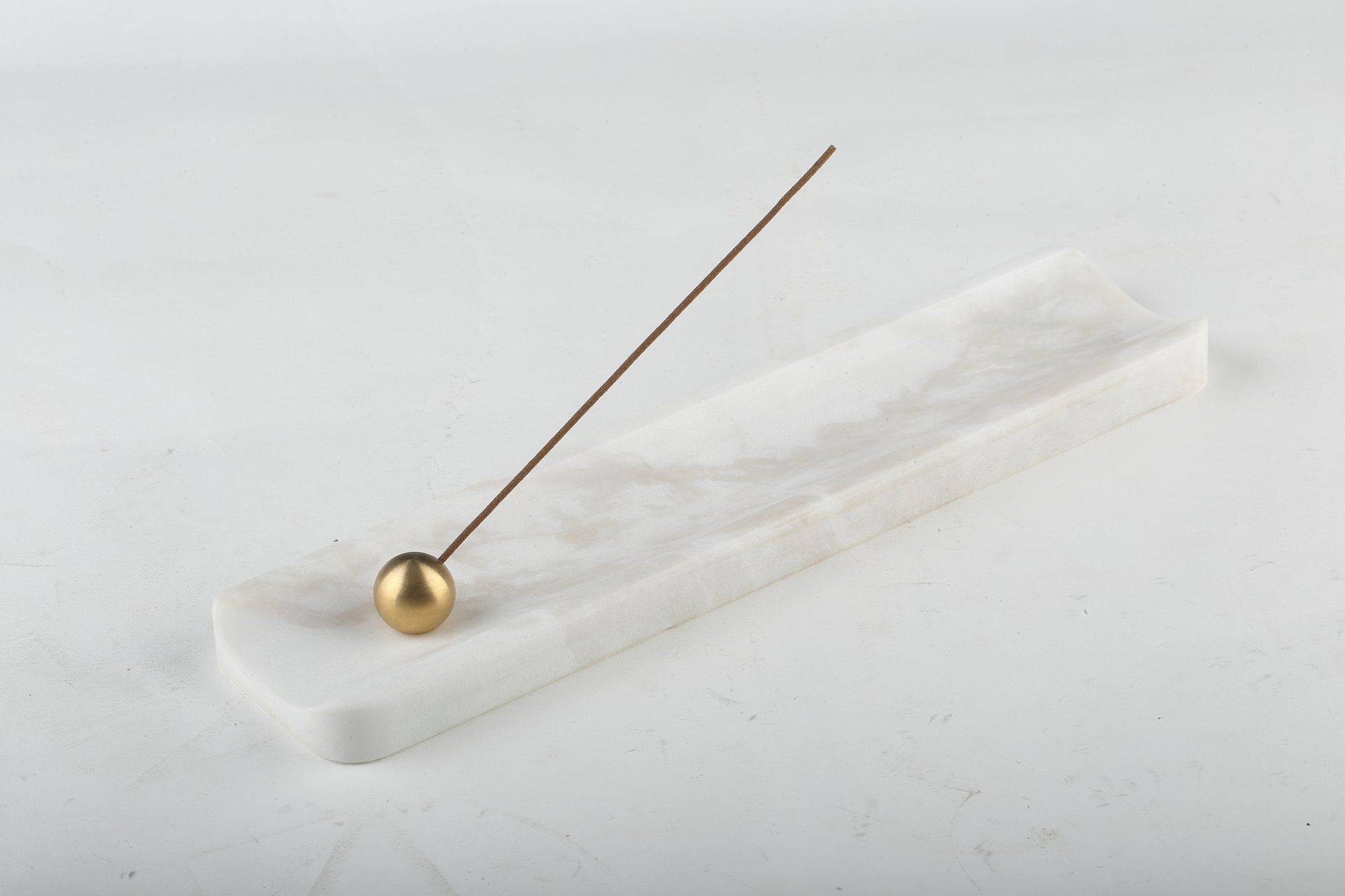 Koville natural marble incense holder in Namib Bianco with burning incense stick