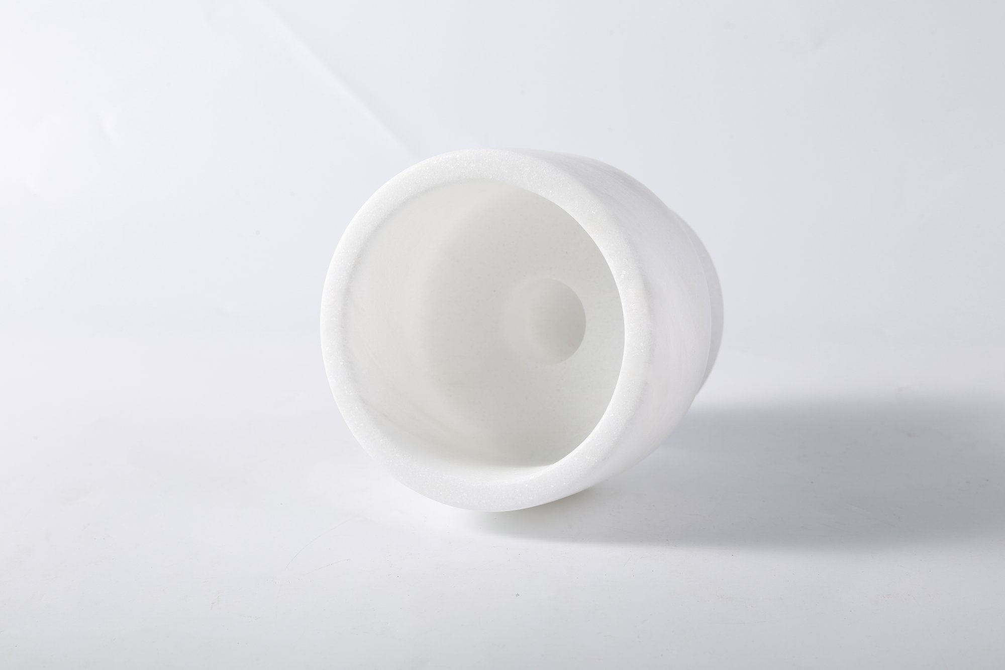 Koville natural marble lighthouse candle holder h 101 6 in Namib Bianco with a lit tea light candle