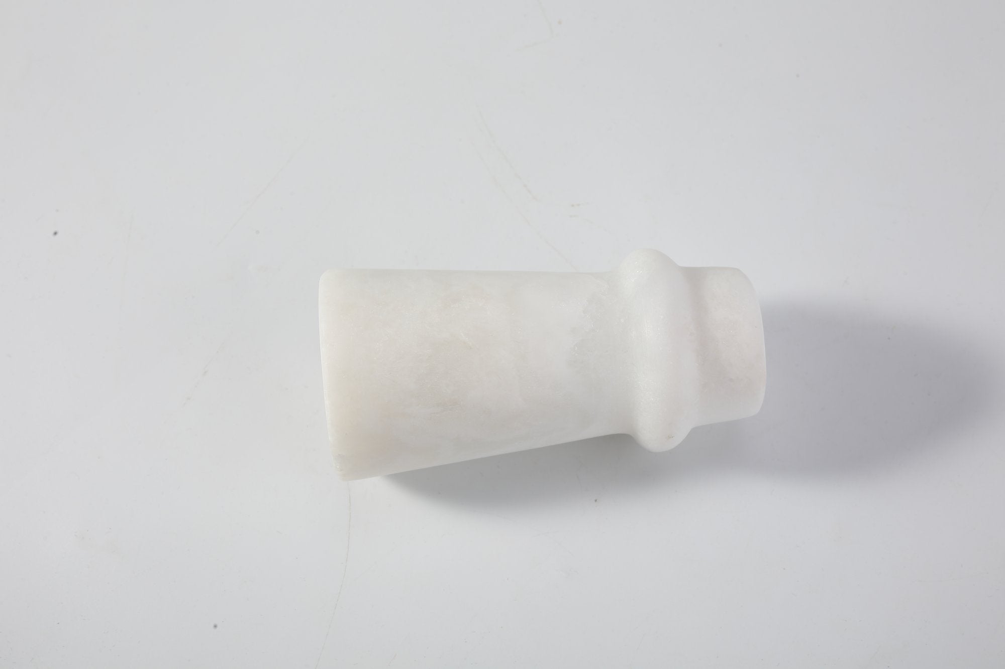 Koville natural marble orbit candle holder d 50 in Namib Bianco with a lit tea light candle