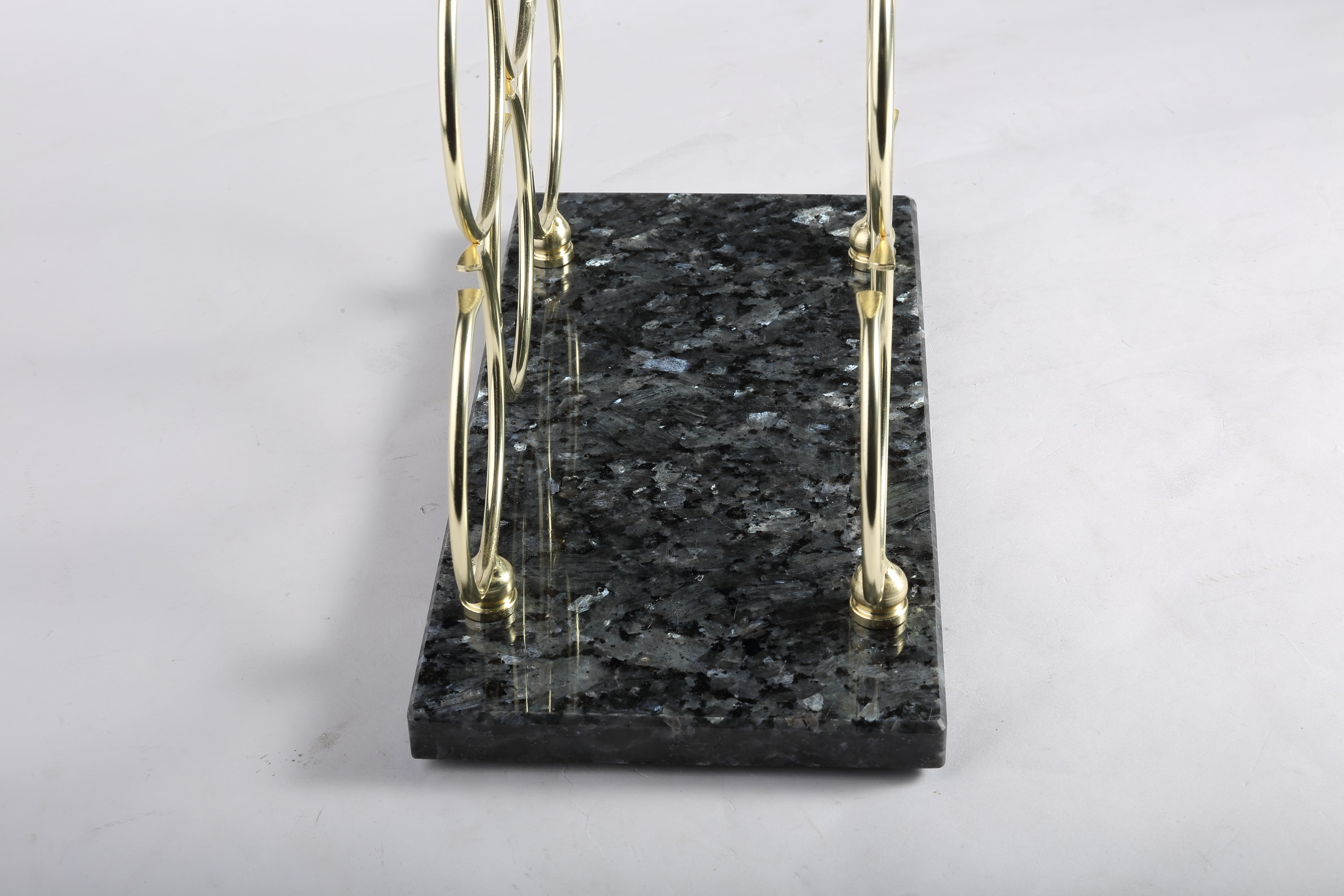 Koville Natural Stone Wine Rack in Blue Pearl on a kitchen counter holding wine bottles