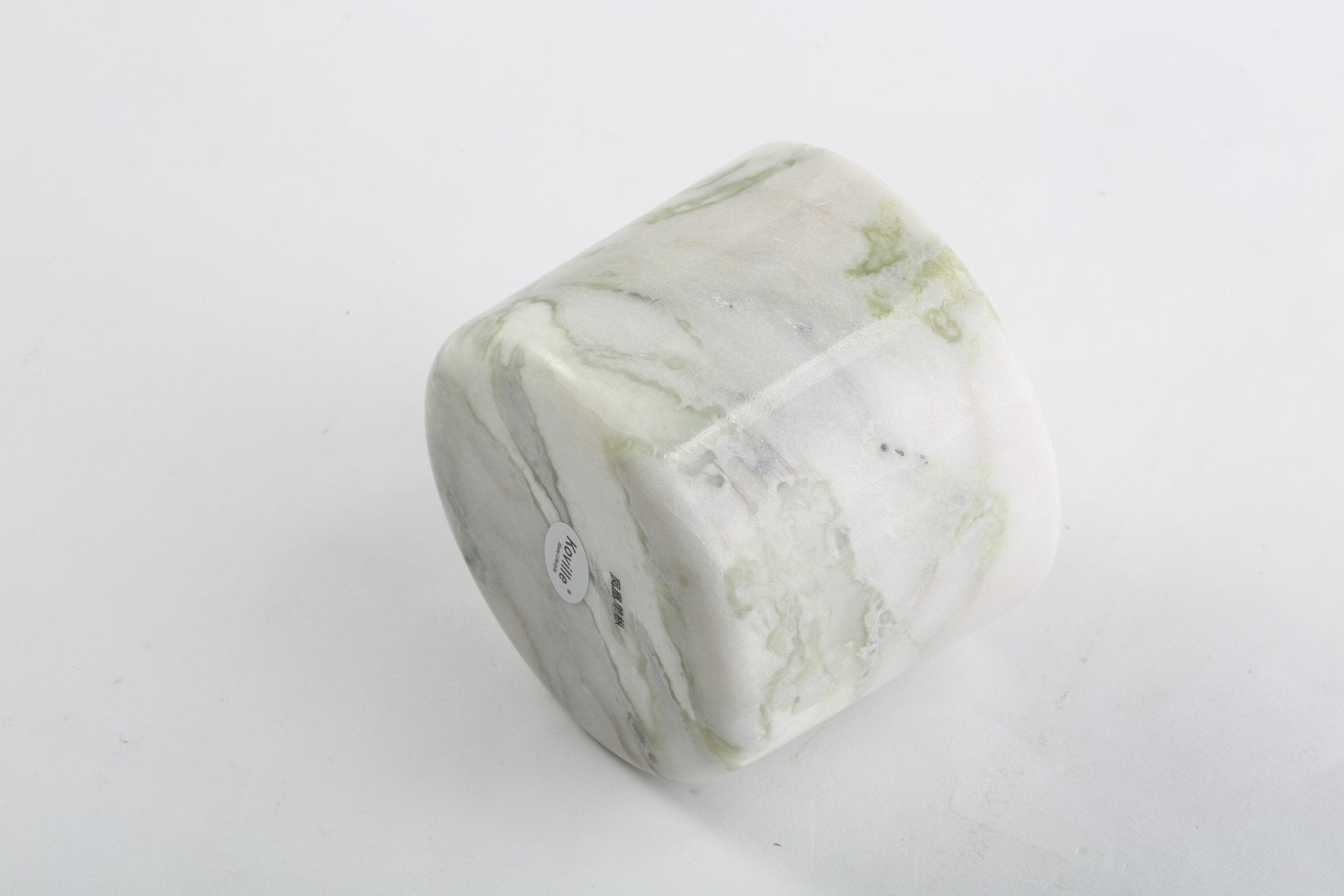 Koville natural marble scented candle d 110 in Bianco Palomino with a lit tea light candle