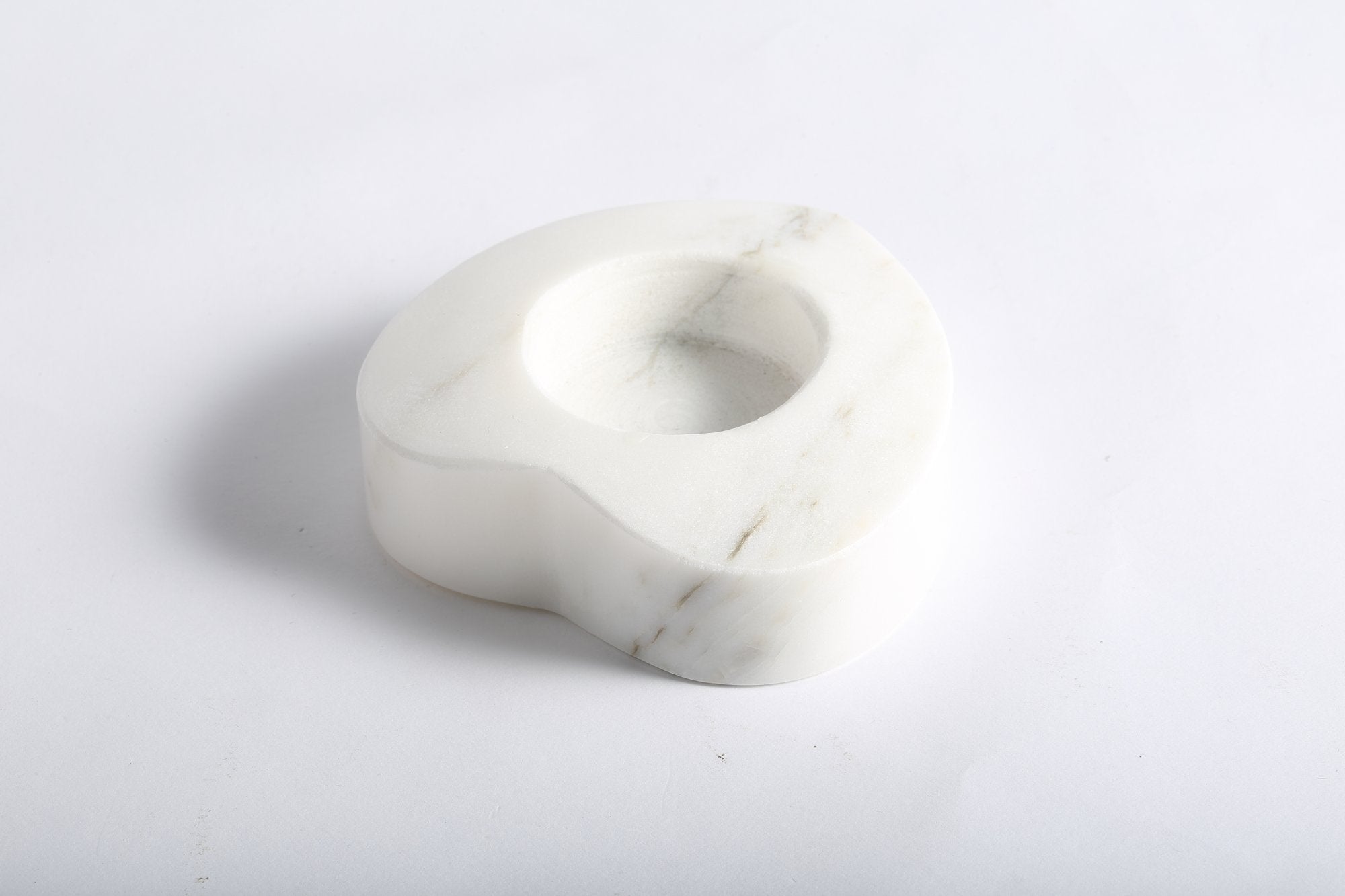 Koville natural marble tea light candle holder t 30 in Sivec with a lit tea light candle