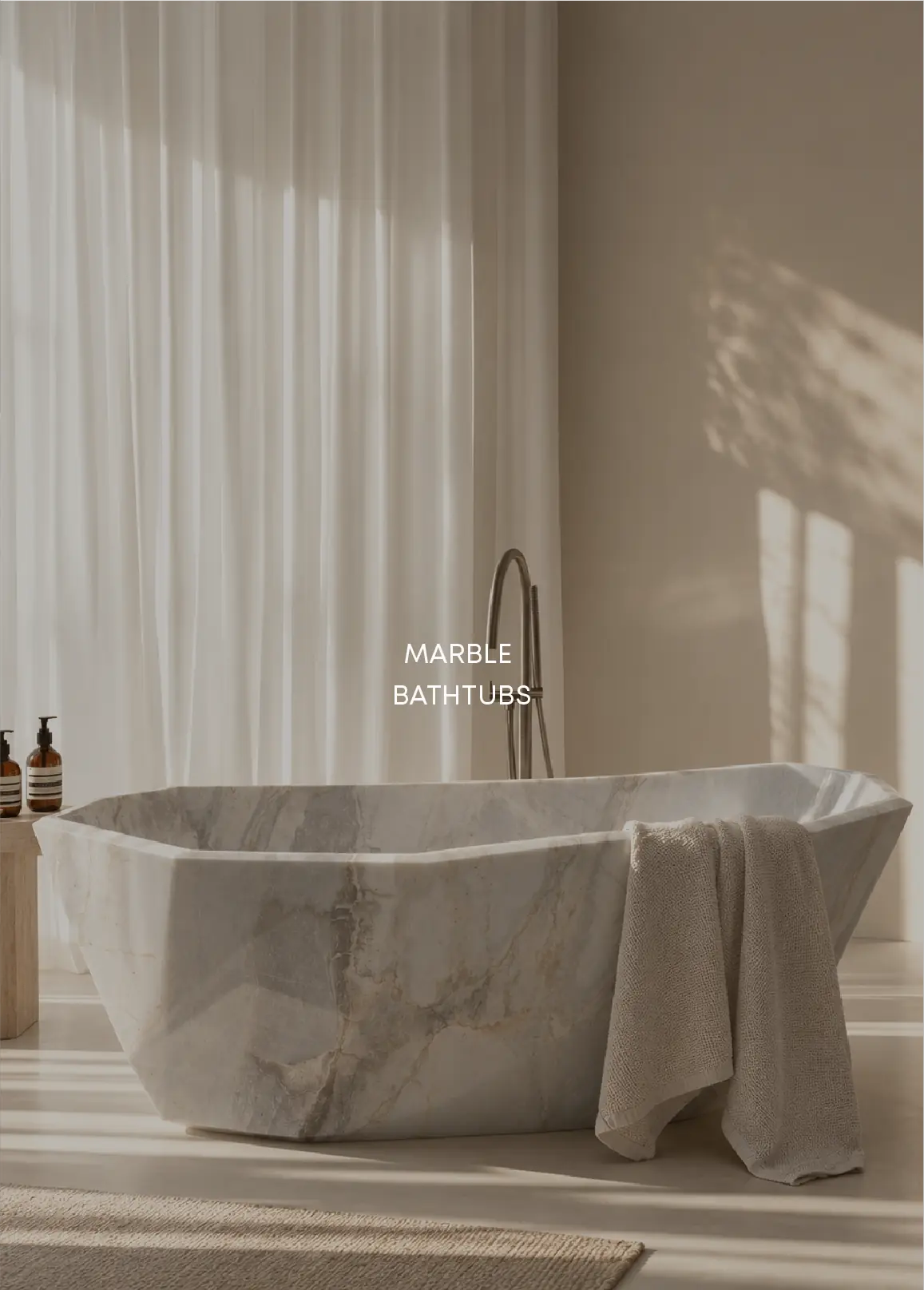 Sculptural bespoke marble bathtub in a softly lit bathroom