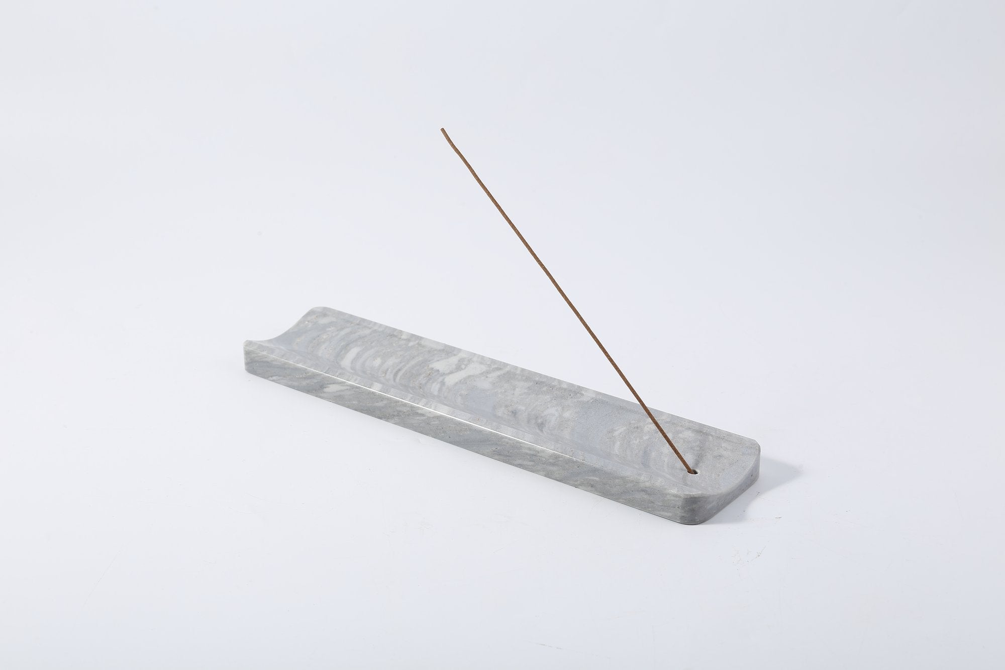 Koville natural marble incense holder slanted hole in Palissandro Blue with burning incense stick