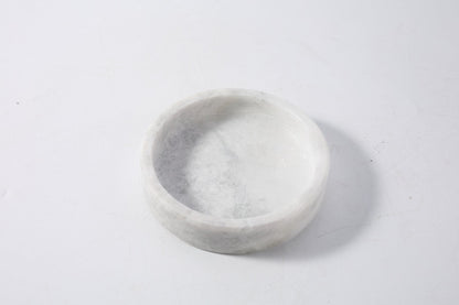 Koville Natural Stone Wine Bottle Holder in Grigio Fantasy on a dining table holding a wine bottle
