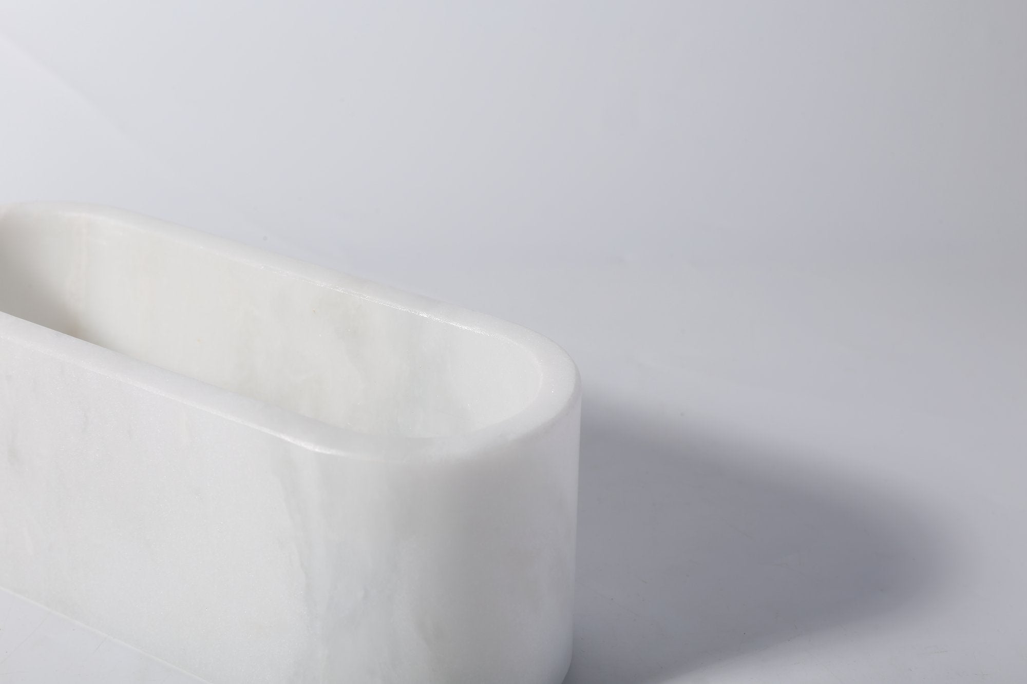 Koville natural marble candlelight cup 200 76 76 in Namib Bianco with a lit tea light candle