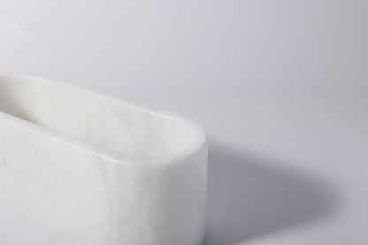 Koville natural marble candlelight cup 200 76 76 in Namib Bianco with a lit tea light candle