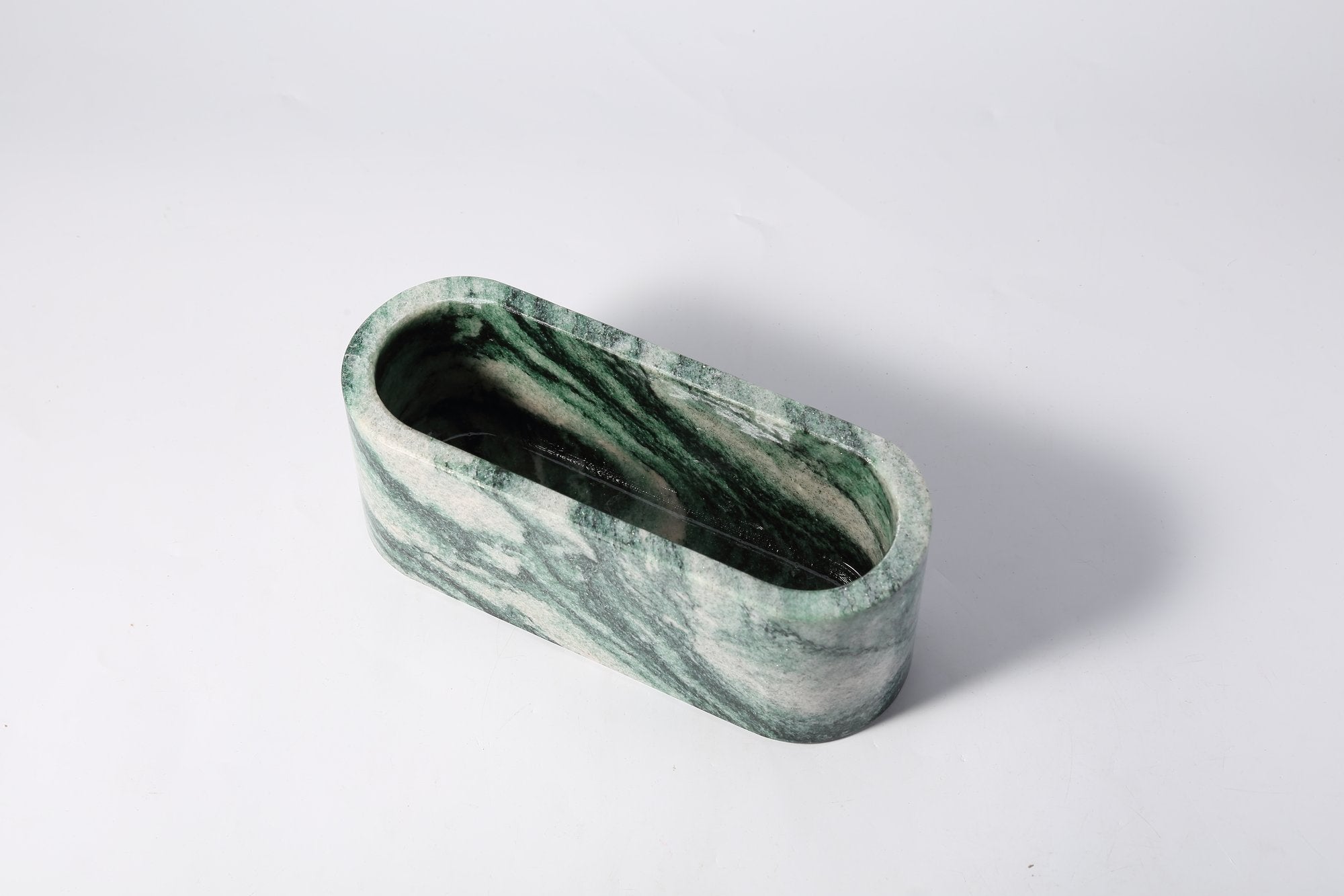 Koville natural marble candlelight cup 200 76 76 in Verde Lapponia with a lit tea light candle