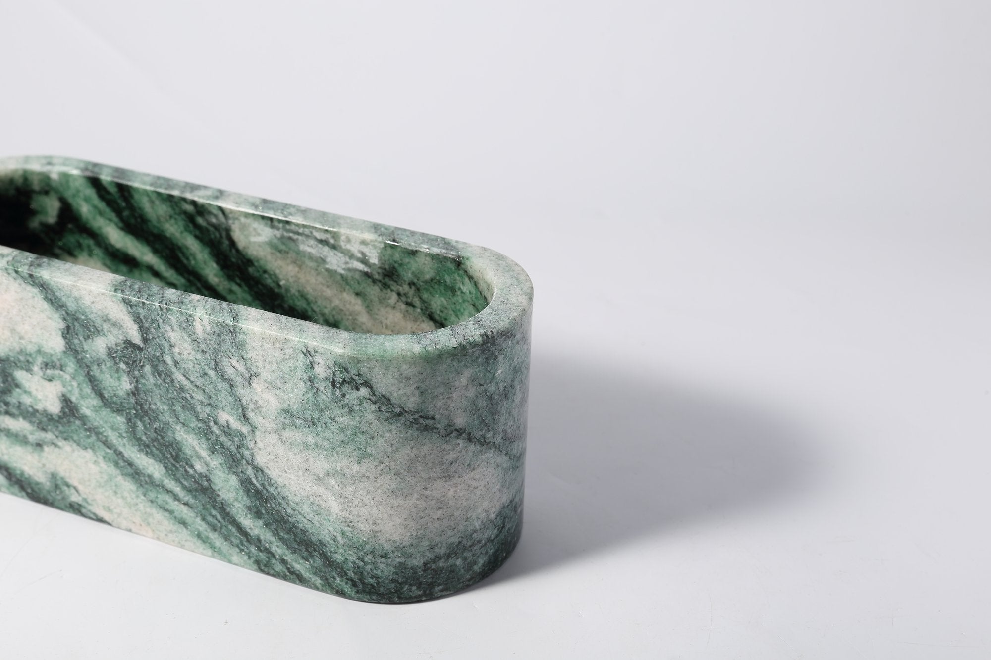 Koville natural marble candlelight cup 200 76 76 in Verde Lapponia with a lit tea light candle