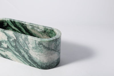 Koville candle holder in Verde Lapponia with a lit tea light candle