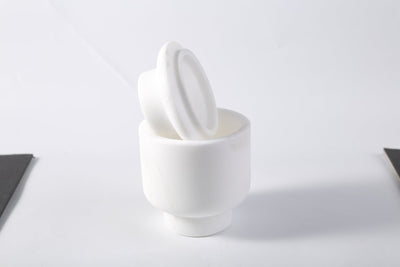 Koville candle holder in Namib Bianco with a lit tea light candle