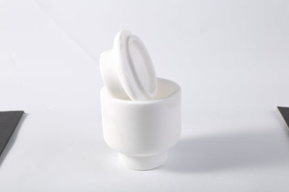 Koville natural marble candlelight cup d 100 t 140 in Namib Bianco with a lit tea light candle