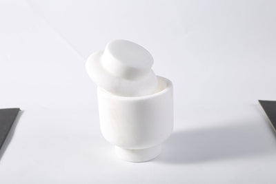 Koville candle holder in Namib Bianco with a lit tea light candle