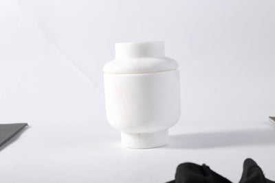 Koville candle holder in Namib Bianco with a lit tea light candle