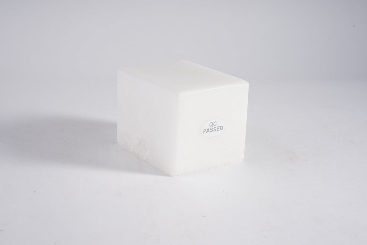 Koville candle holder in Namib Bianco with a lit tea light candle