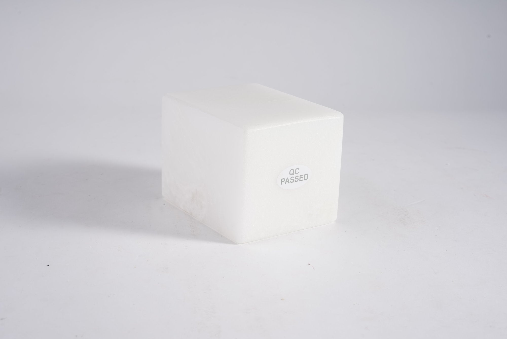 Koville natural marble candlelight cup d 70 in Namib Bianco with a lit tea light candle
