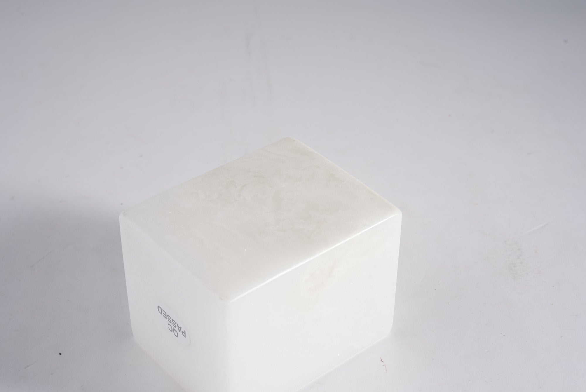 Koville natural marble candlelight cup d 70 in Namib Bianco with a lit tea light candle