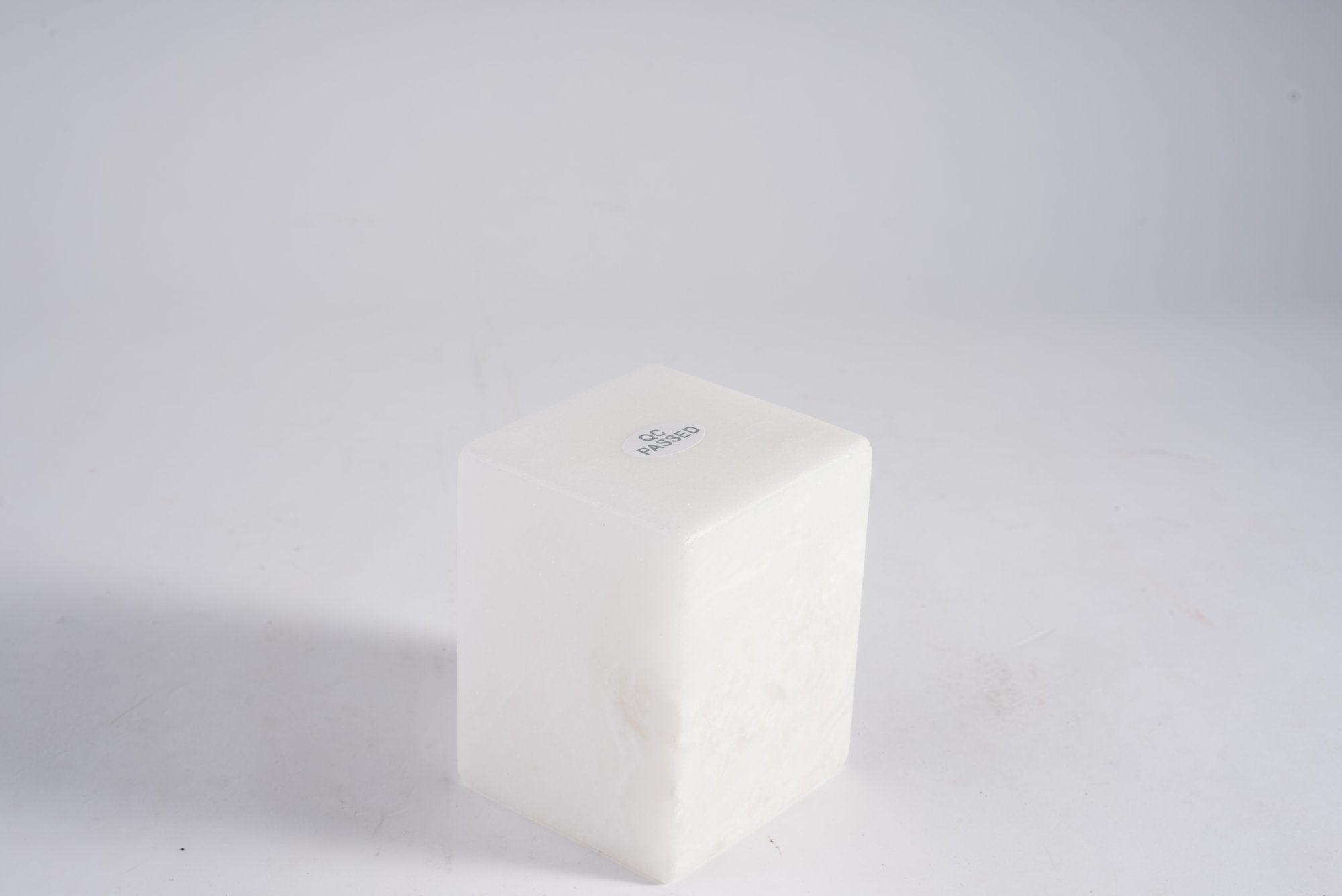 Koville natural marble candlelight cup d 70 in Namib Bianco with a lit tea light candle