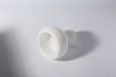 Koville candle holder in Namib Bianco with a lit tea light candle