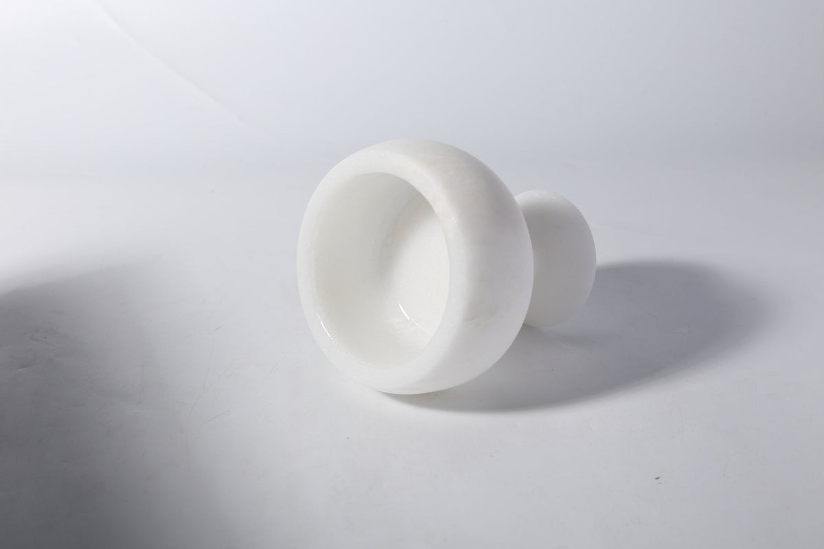 Koville candle holder in Namib Bianco with a lit tea light candle