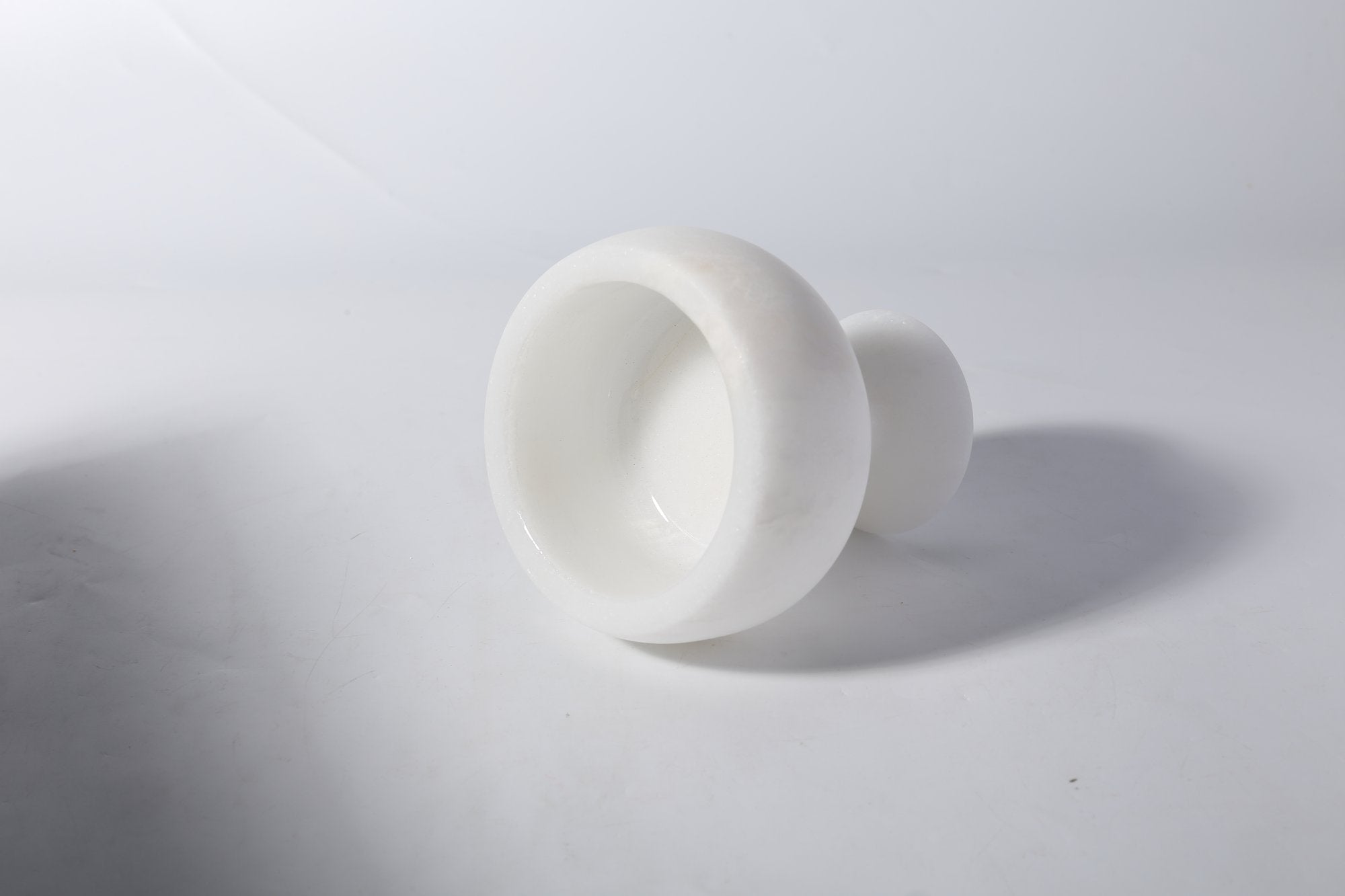 Koville natural marble candlelight cup d 99 in Namib Bianco with a lit tea light candle