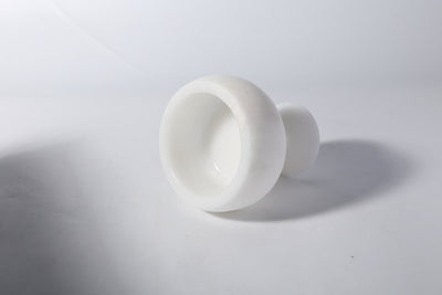 Koville candle holder in Namib Bianco with a lit tea light candle