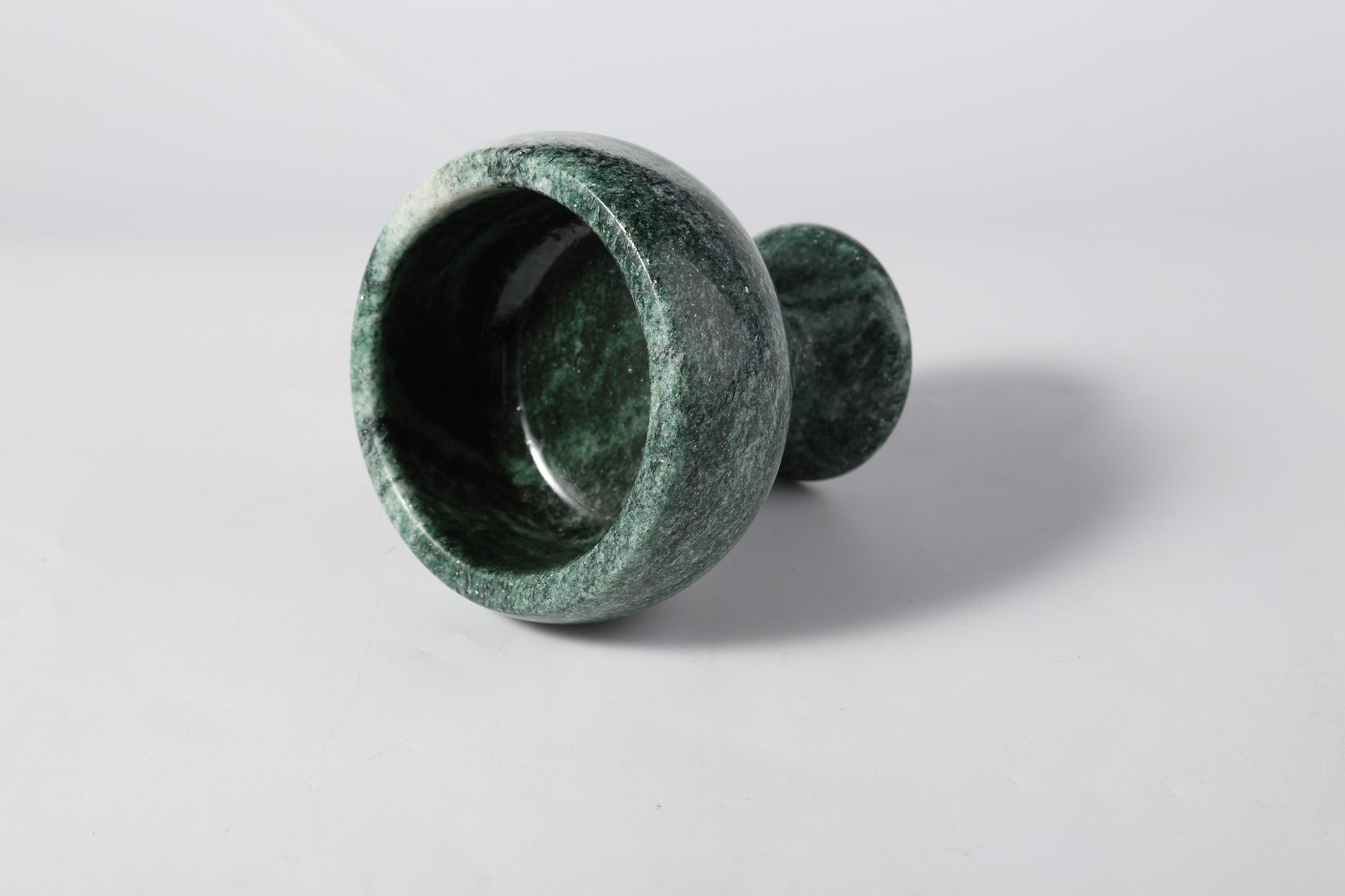 Koville natural marble candlelight cup d 99 in Verde Lapponia with a lit tea light candle