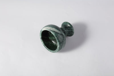 Koville candle holder in Verde Lapponia with a lit tea light candle