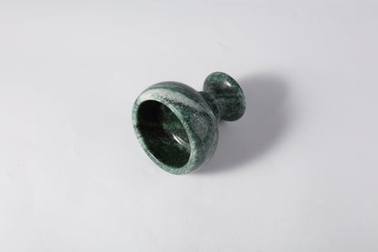 Koville natural marble candlelight cup d 99 in Verde Lapponia with a lit tea light candle