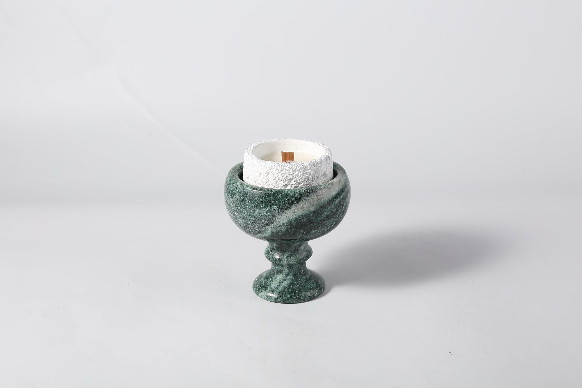 Koville natural marble candlelight cup d 99 in Verde Lapponia with a lit tea light candle