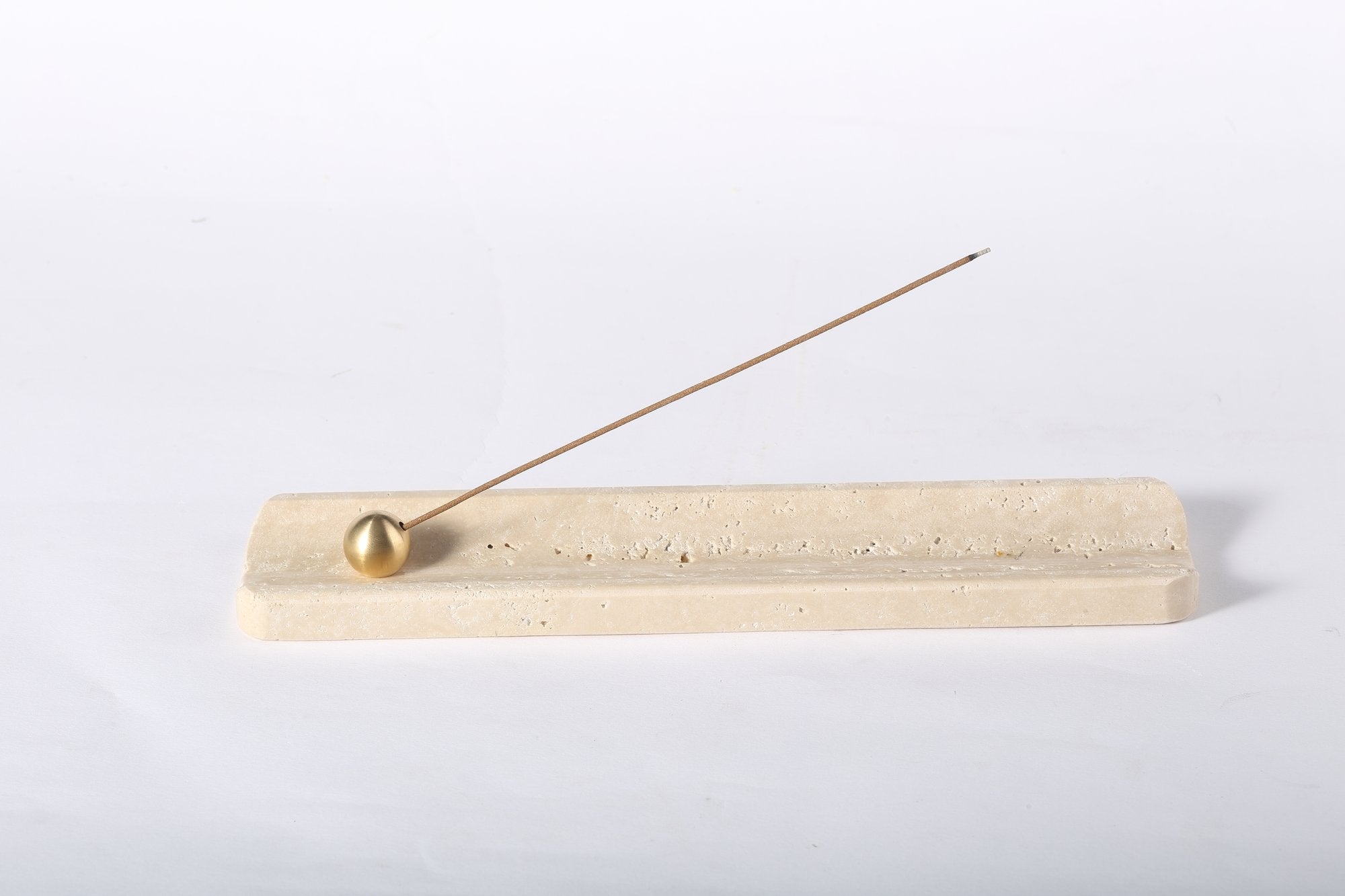 Koville natural marble incense holder in Travertino Romano with burning incense stick
