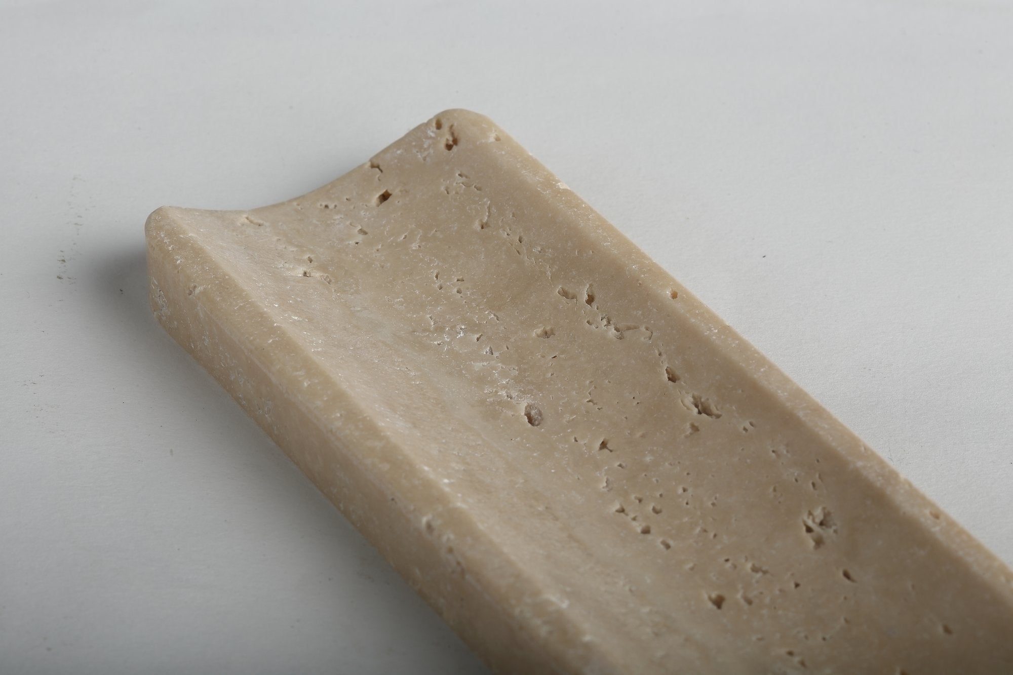 Koville natural marble incense holder in Travertino Romano with burning incense stick
