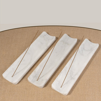 Koville natural marble incense holder slanted hole in Bianco Carrara with burning incense stick