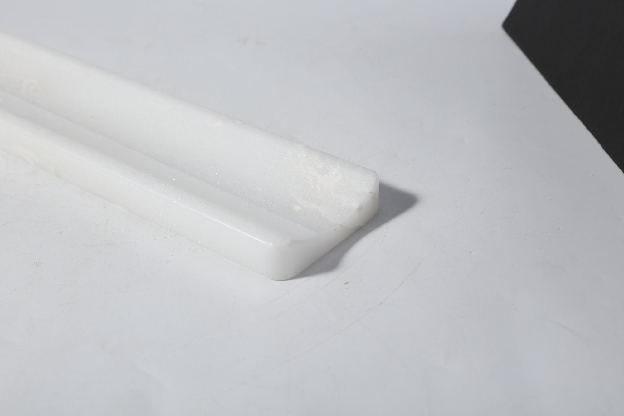 Koville natural marble incense holder slanted hole in Namib Bianco with burning incense stick