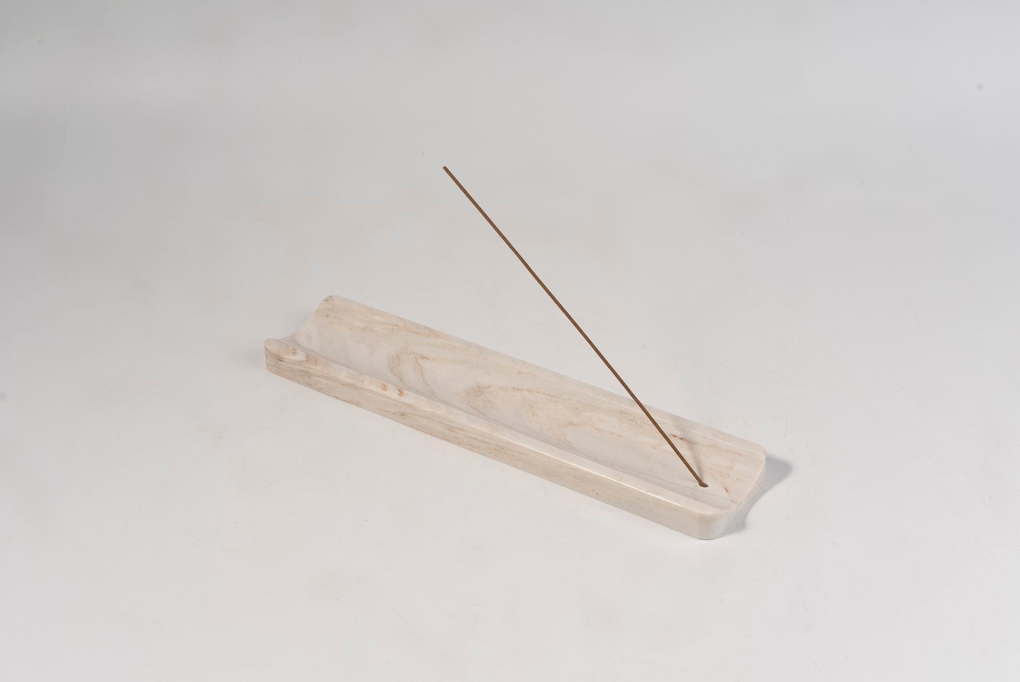 Koville natural marble incense holder slanted hole in Palissandro Classico with burning incense stick