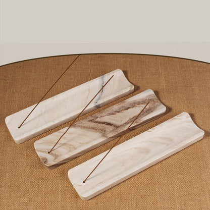 Koville natural marble incense holder slanted hole in Palissandro Classico with burning incense stick