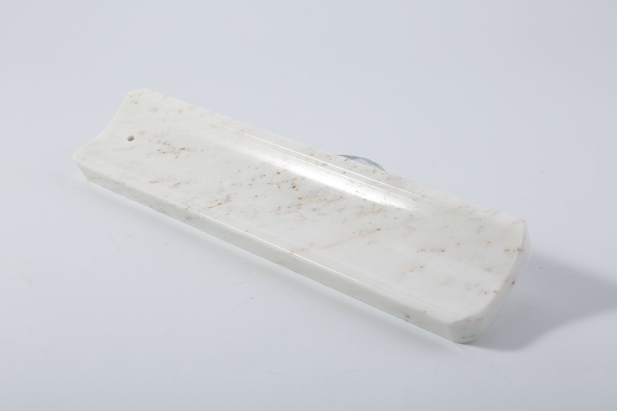 Koville natural marble incense holder slanted hole in Palissandro Classico with burning incense stick