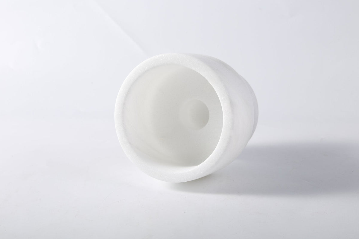 Koville candlestick in Namib Bianco with a lit tea light candle