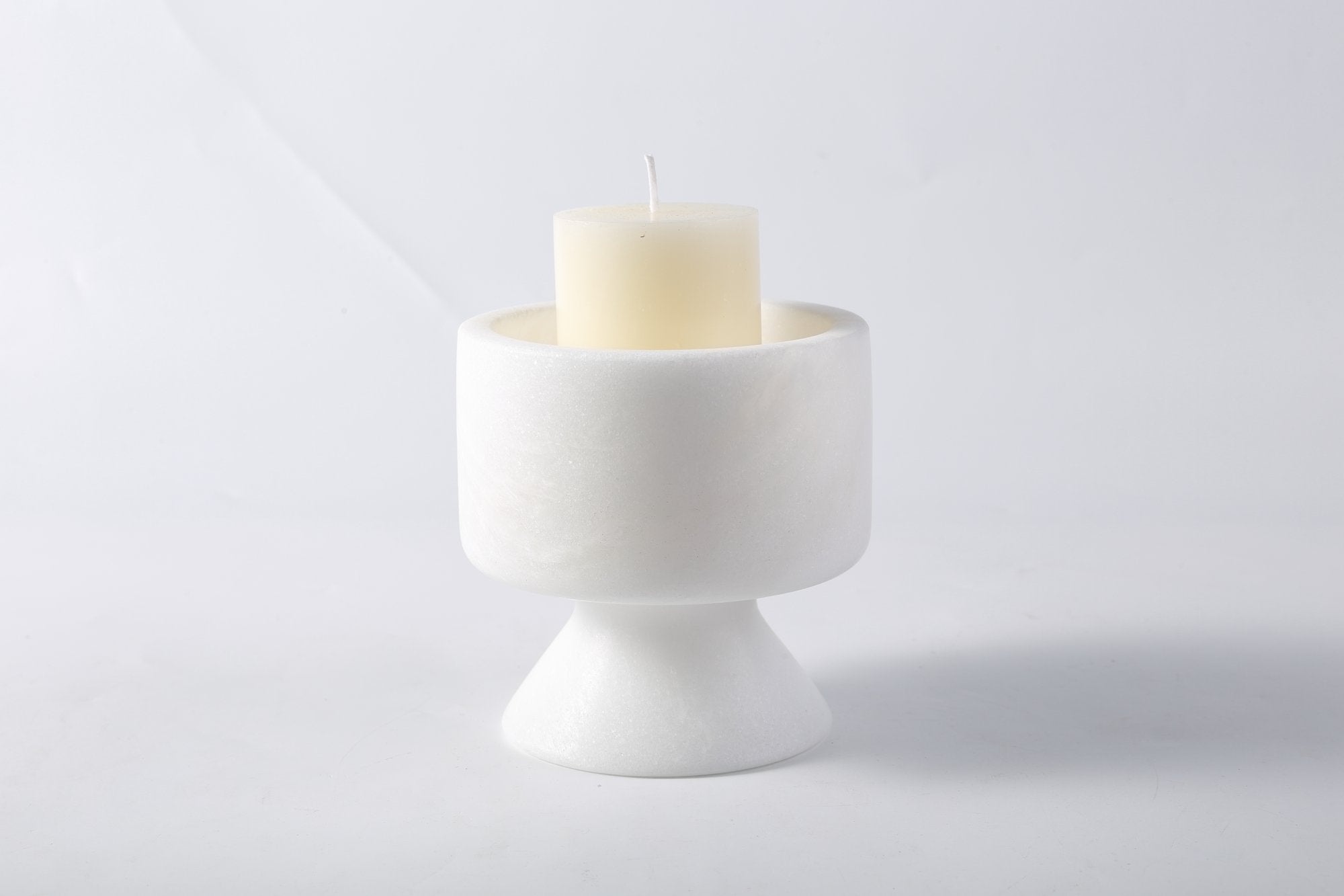 Koville natural marble lighthouse candle holder h 101 6 in Namib Bianco with a lit tea light candle