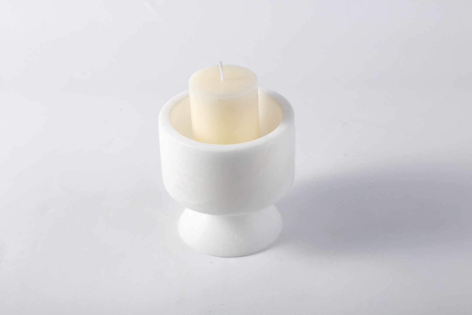 Koville natural marble lighthouse candle holder h 101 6 in Namib Bianco with a lit tea light candle